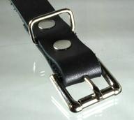 A slim line roller buckle on a leather strap.